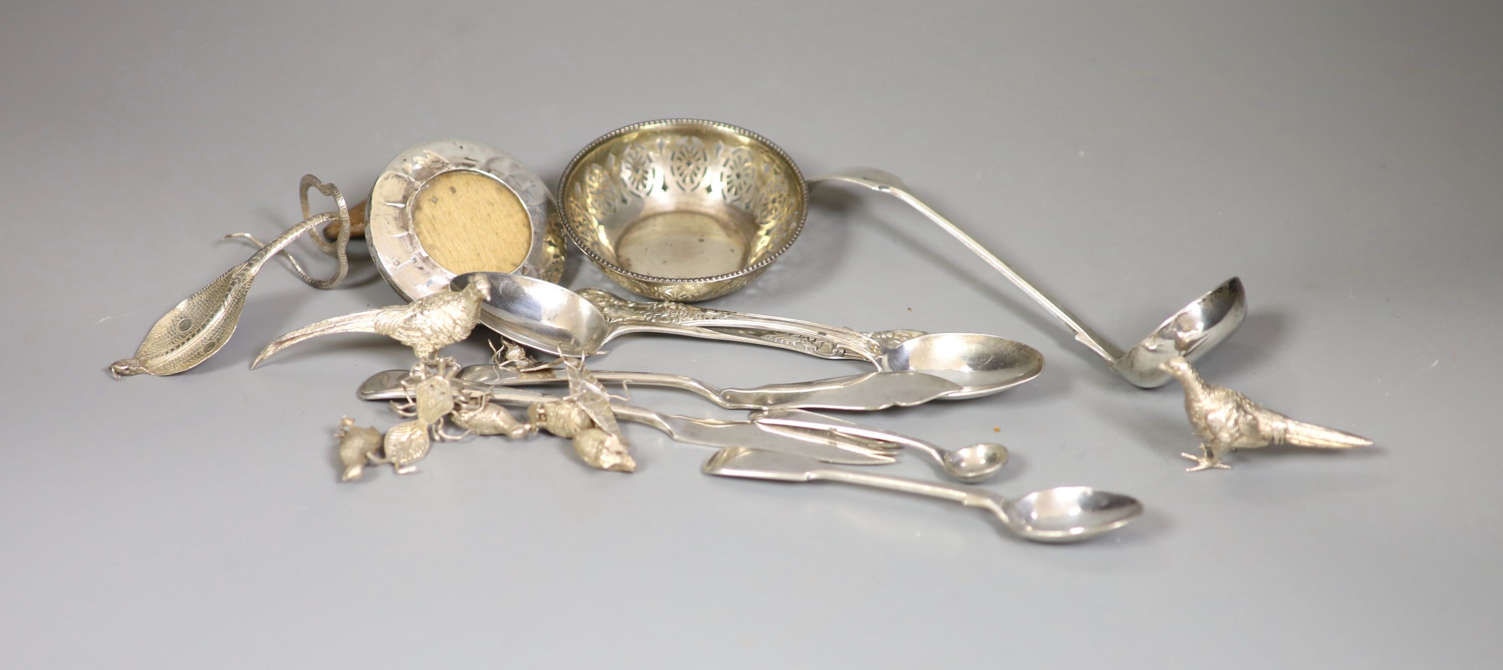 A Victorian silver fiddle pattern sauce ladle, two Victorian Scottish silver teaspoons, a pierced silver small bowl, small silver mounted photograph frame and thirteen other items including silver plated miniature animal